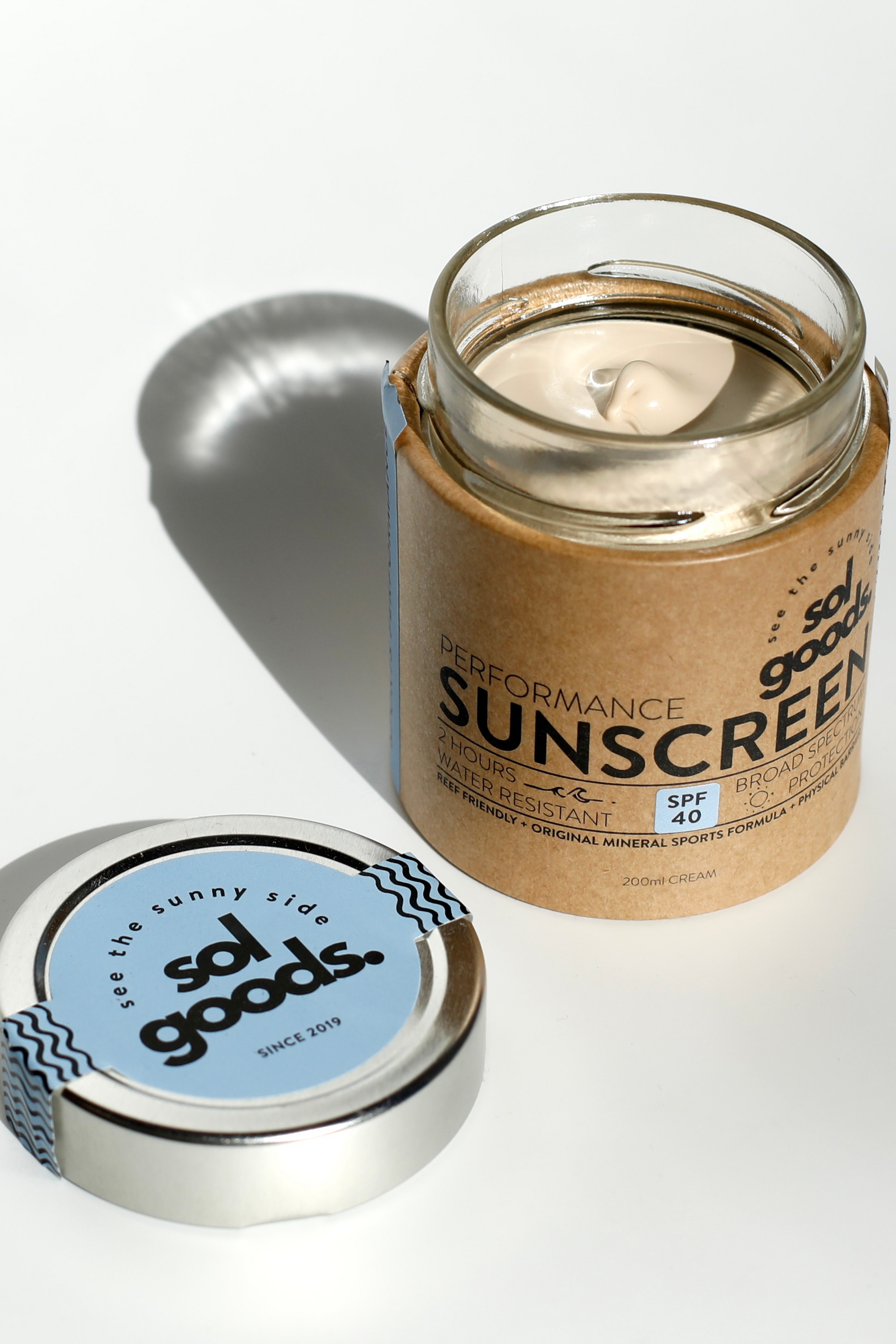 Solu Goods performance sunscreen jar with a silver lid on a white background